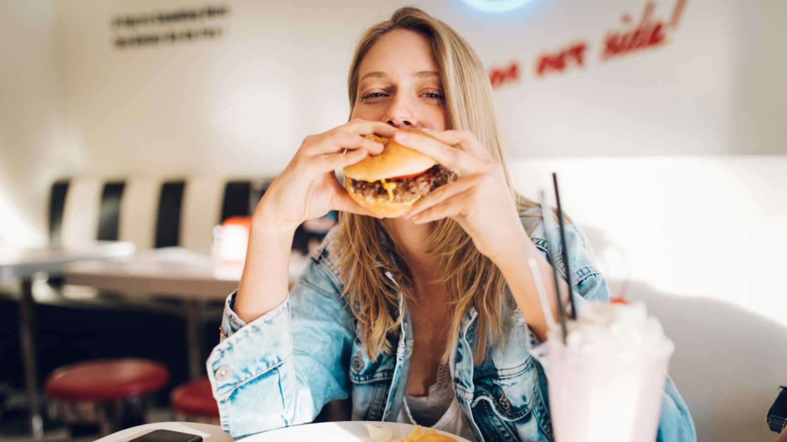 Woman eating Burger