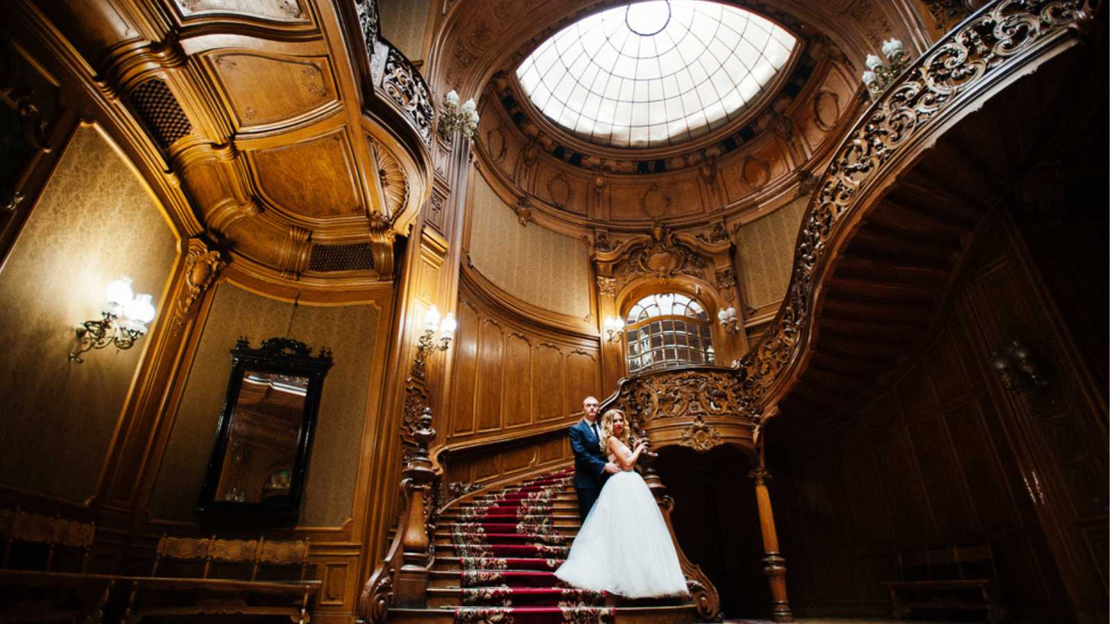 Elegant wedding couple at old vintage house and palace with big wooden stairs