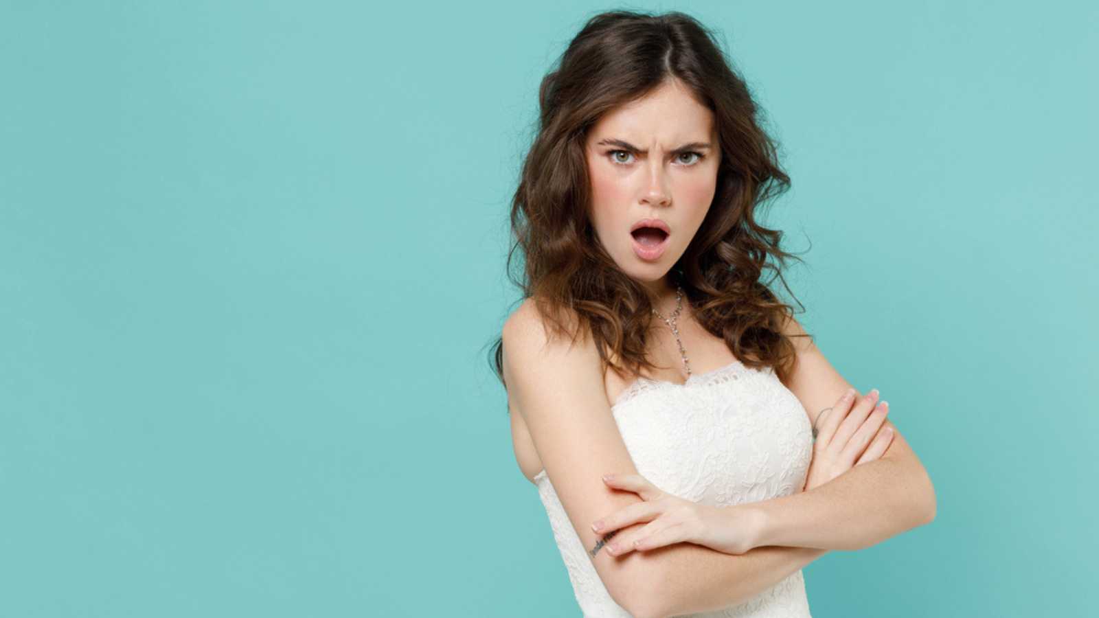 Woman giving angry look with folded hands reaction