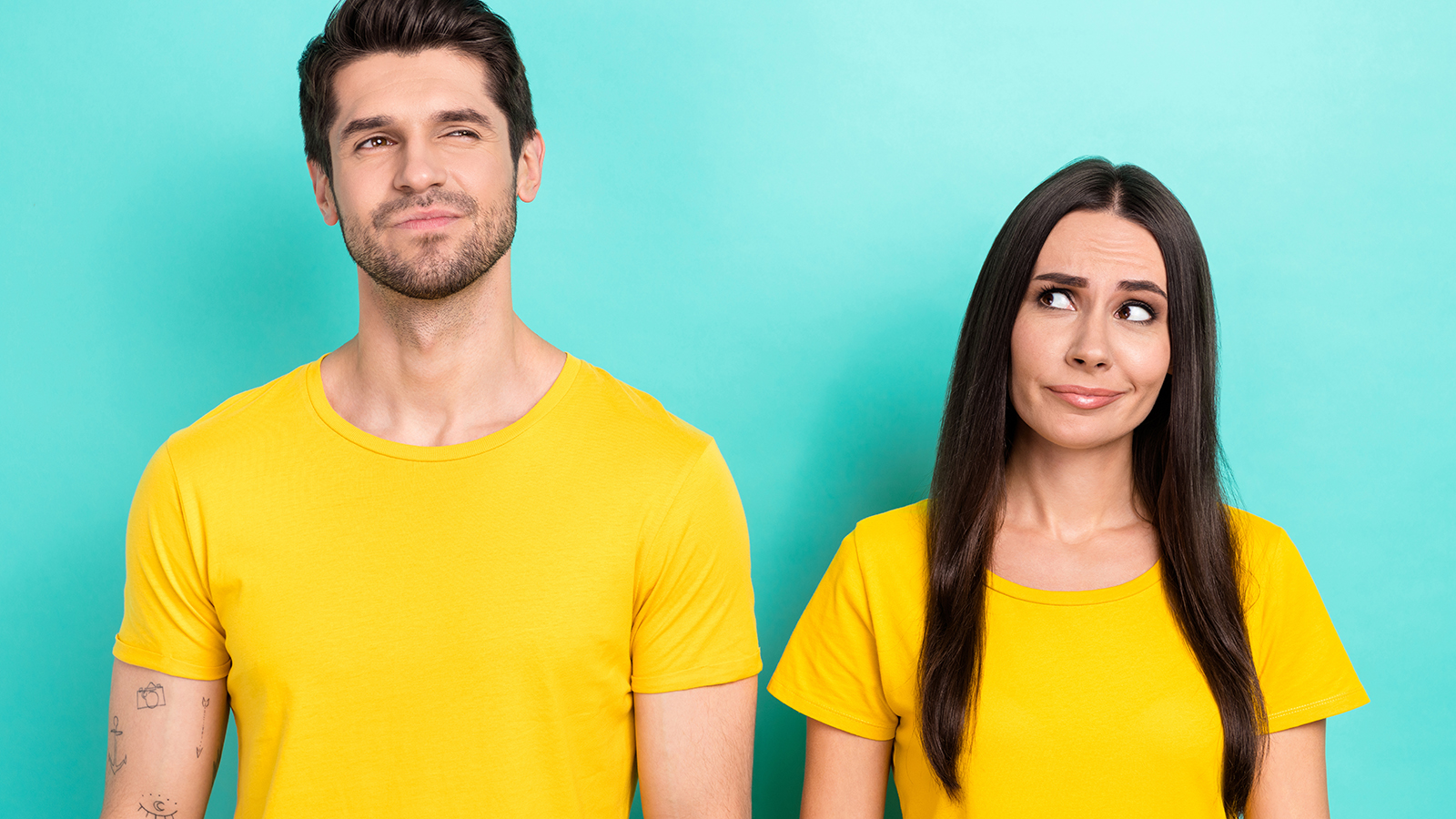 Photo of brainstorming young couple partners wear yellow t-shirt thinking solution how save more money isolated on aquamarine color background.