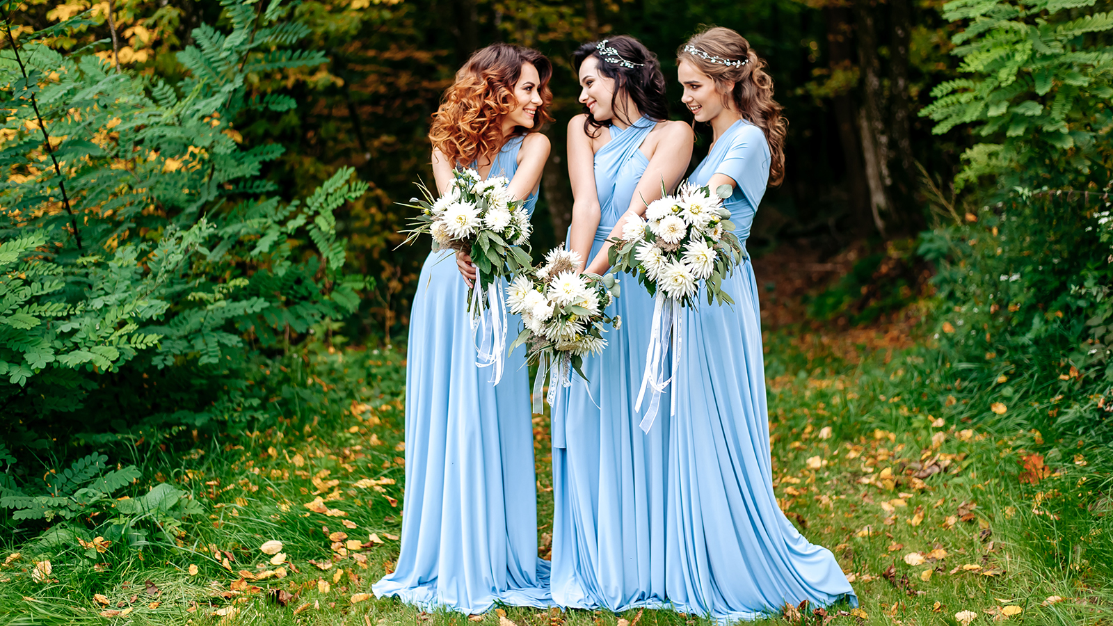 Beautiful cute girls are walking in the park. Three bridesmaids posing for a photographer. Beautiful green background. Nature.