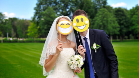 bride and groom with paper smileys