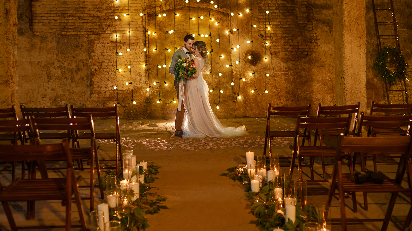 Stylish hipster wedding couple in romantic loft decorations at night