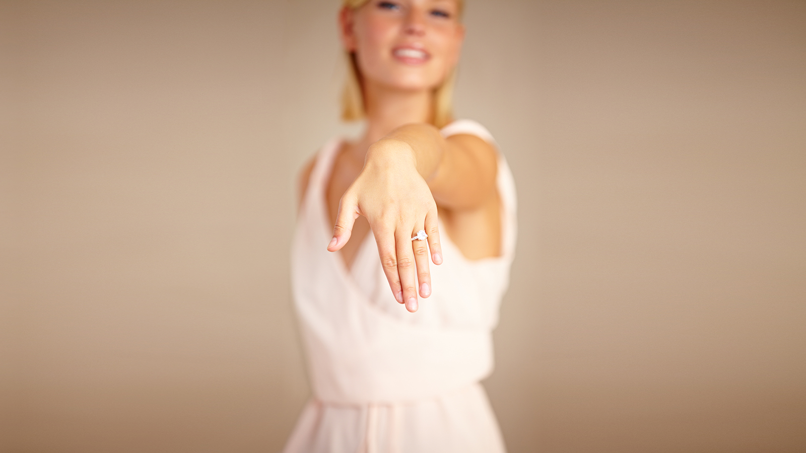 Cropped shot of a young woman displaying her engagement ring.