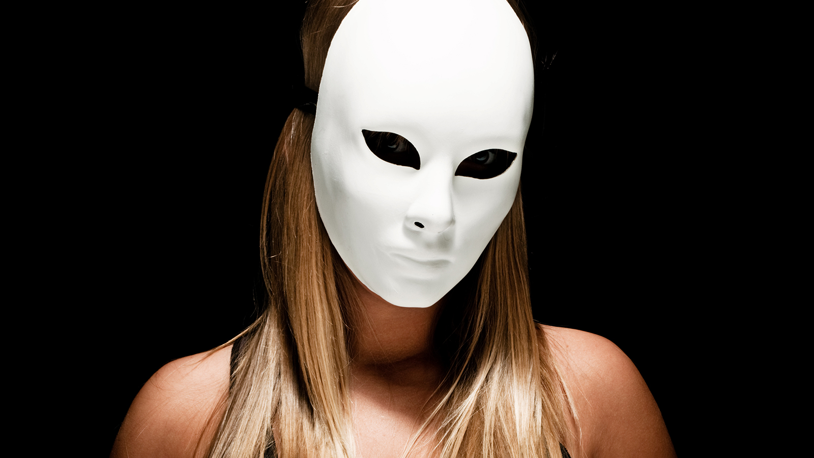 blond woman with white mask, studio dark