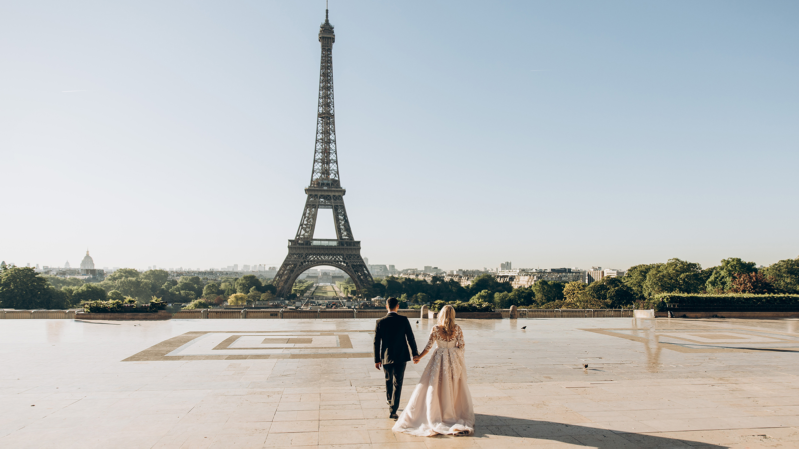 Bride and groom enjoying their wedding in Paris, against the backdrop of the Eiffel Tower
