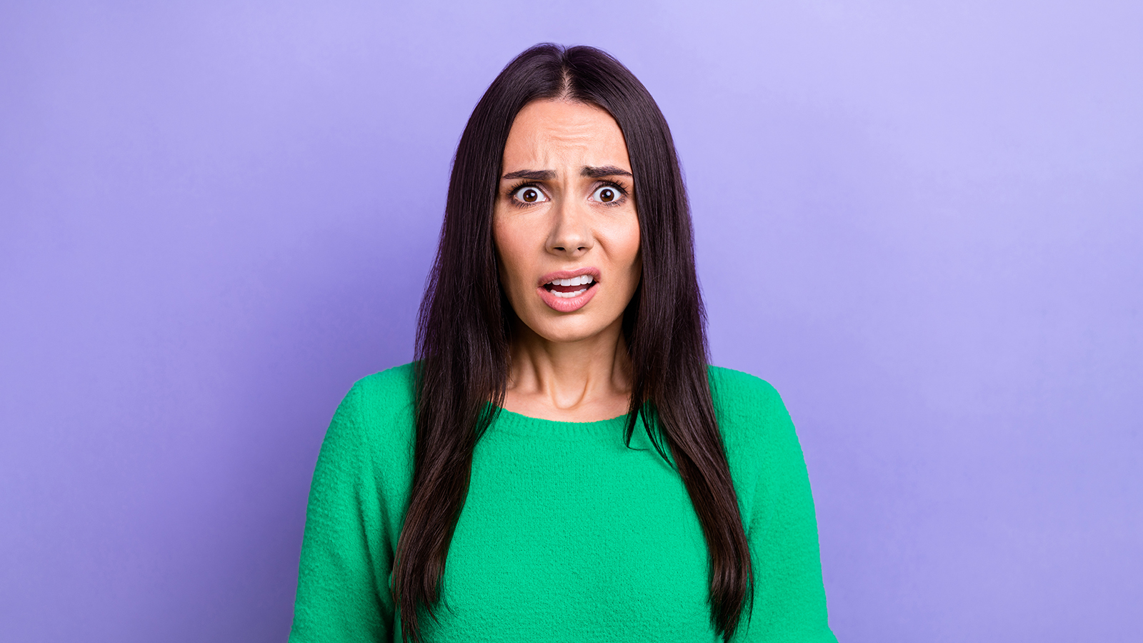 Photo of shocked impressed lady dressed green sweater listening bad news isolated violet color background.