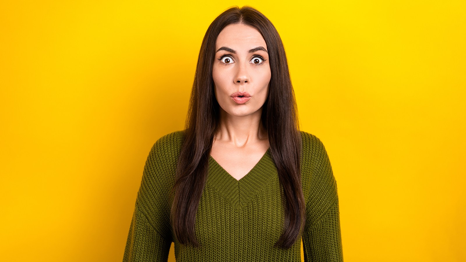 Portrait of shocked speechless girl pouted lips staring cant believe isolated on yellow color background.