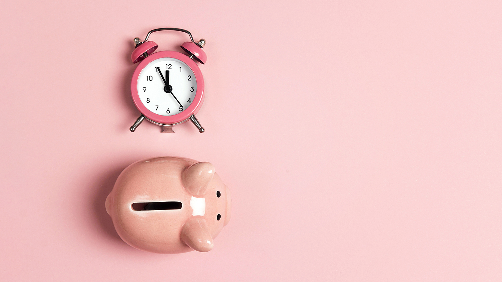 Piggy bank and classic alarm clock on pink background. Time to saving, money, banking concept. Flat design, copy space, top down composition.