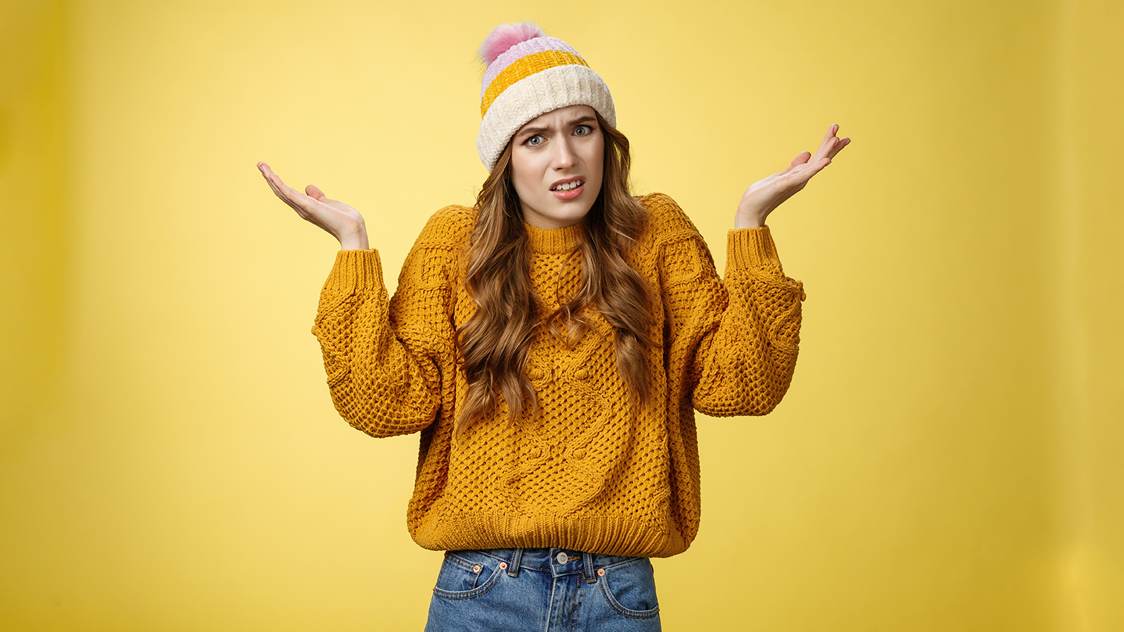 What fuss about. Annoyed confused intense perplexed young attractive woman wearing sweater hat raising hands dismay shrugging cringing grimacing frustrated arguing clueless what happened
