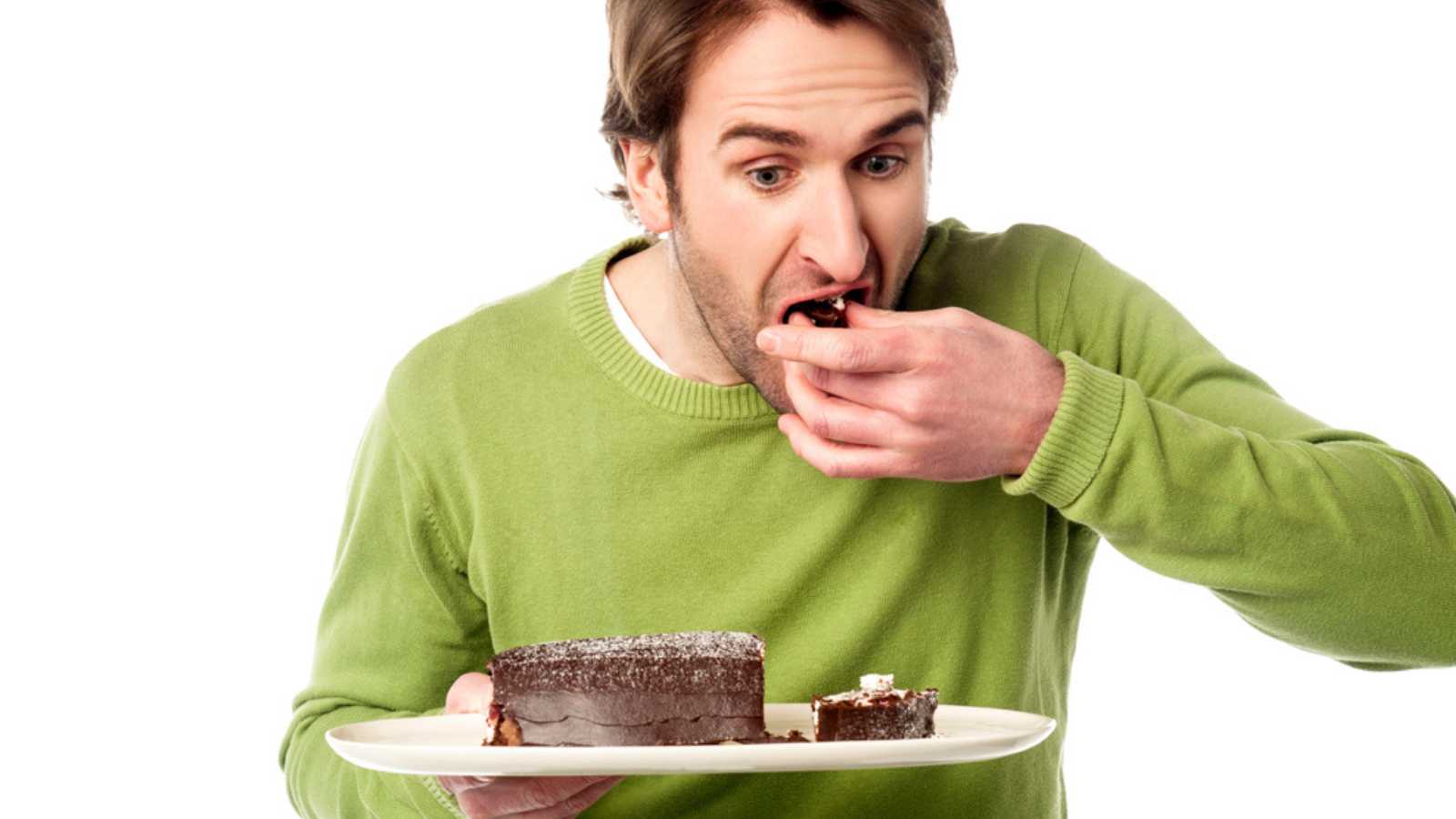 Man eating slice of cake