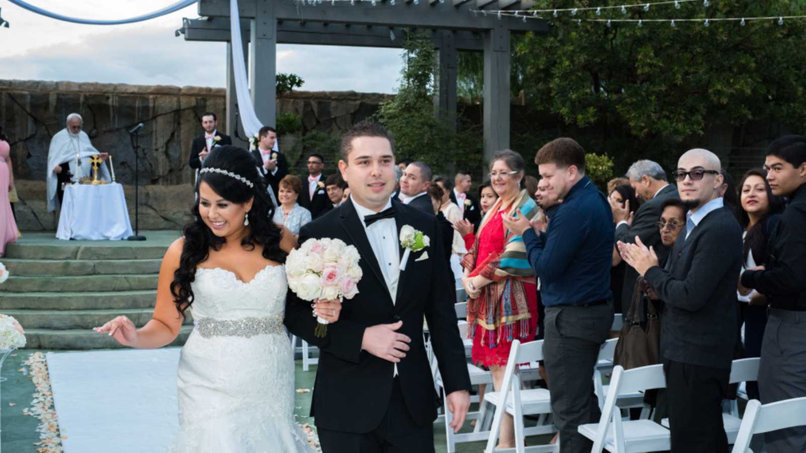 Recently married couple walks down the aisle