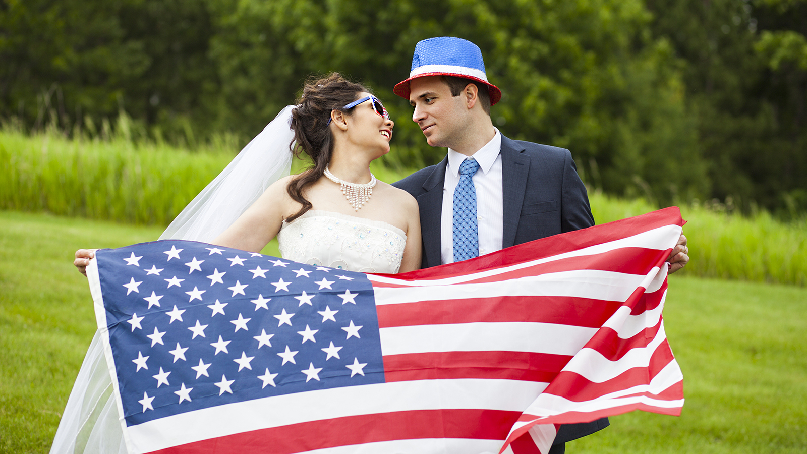 Patriotic holiday married couple with American flag for july 4th