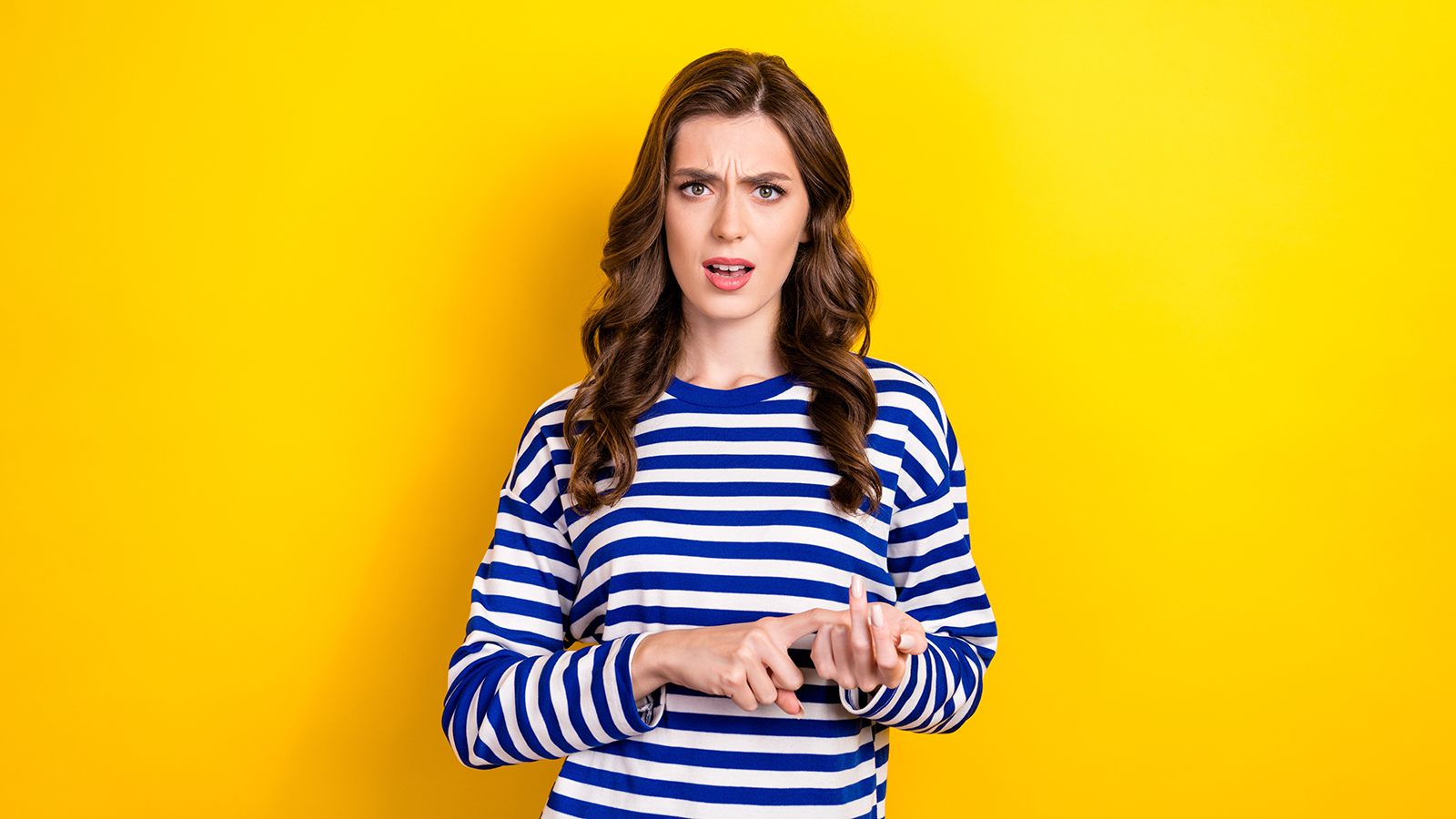 Photo portrait of attractive young woman calculate fingers scold annoyed dressed stylish striped look isolated on yellow color background