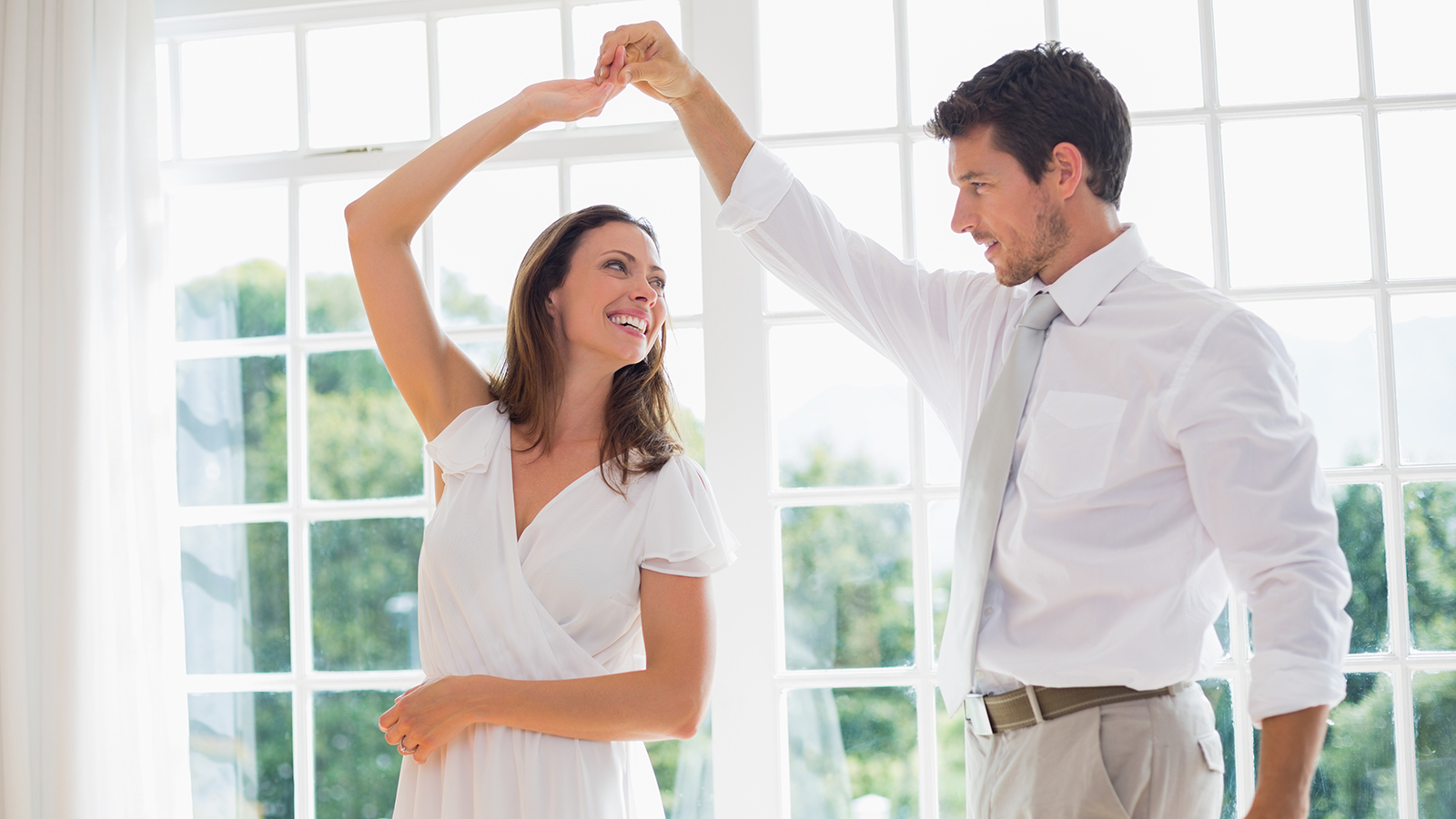Loving couple dancing at home