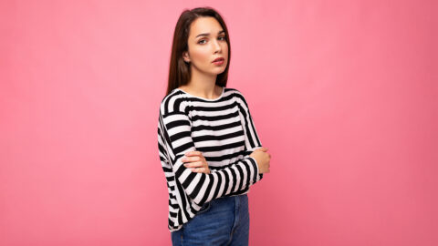 Photo shot of nice attractive pretty young sad upset sorrowful brunette woman wearing casual striped longsleeve isolated over colorful background with copy space