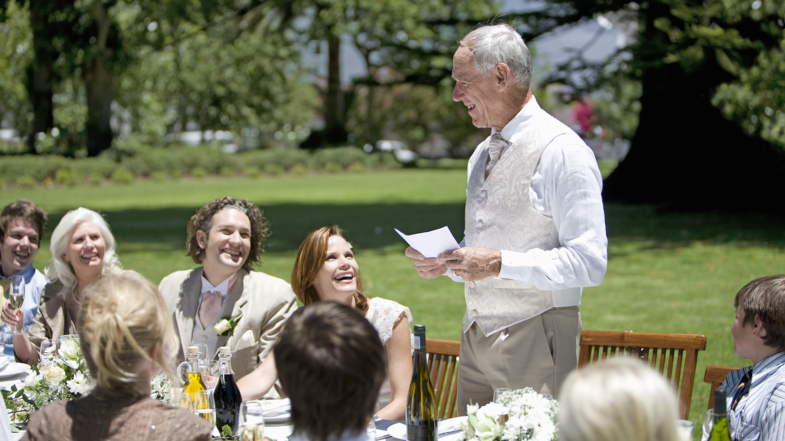 Senior man making a speech at a wedding reception