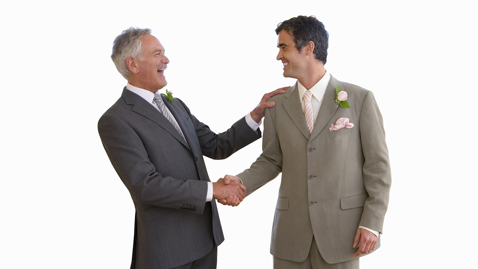 Groom and usher shaking hands, smiling at each other, side view, cut out