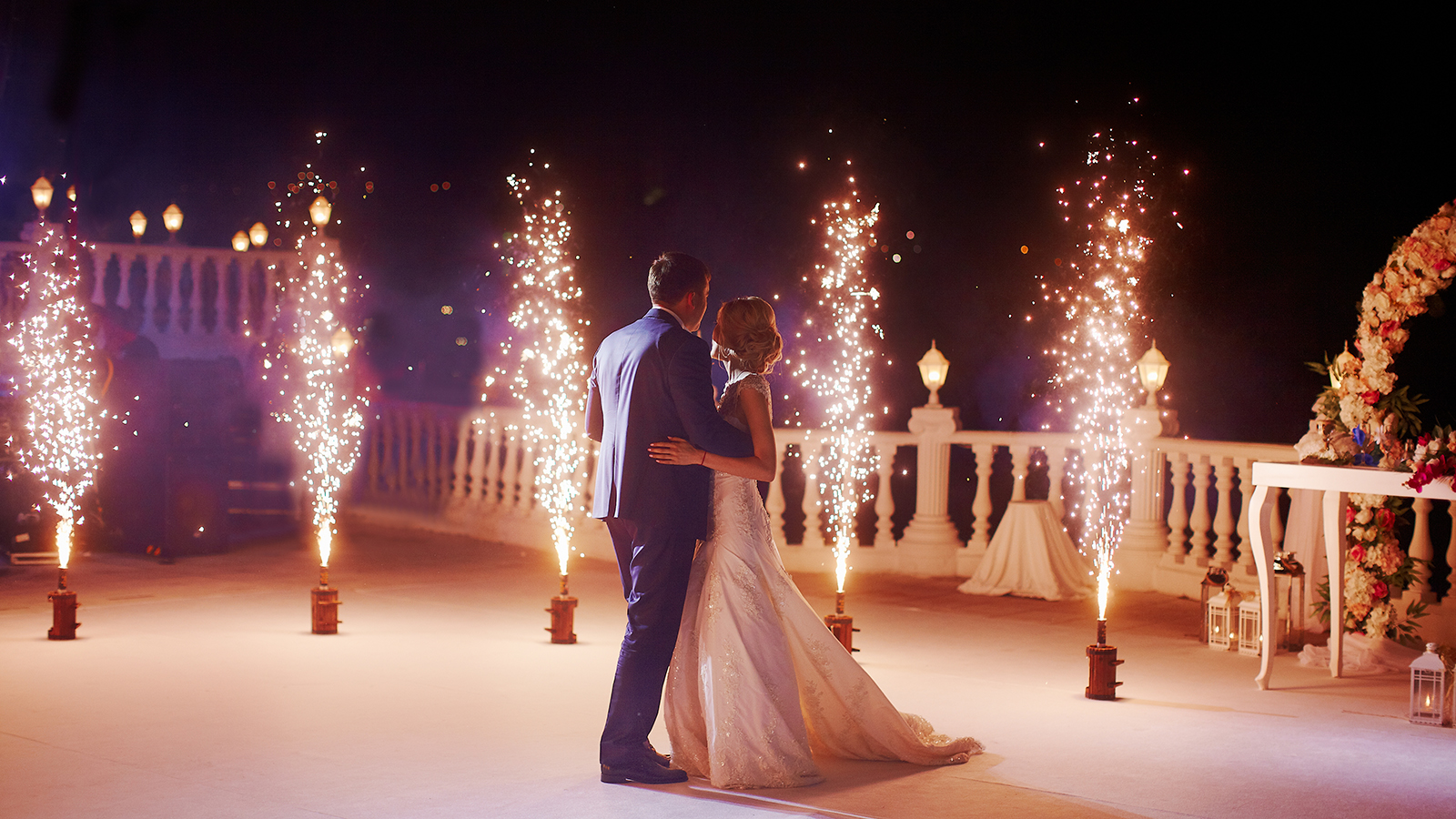 Wedding couple dancing in sparklers their first dance