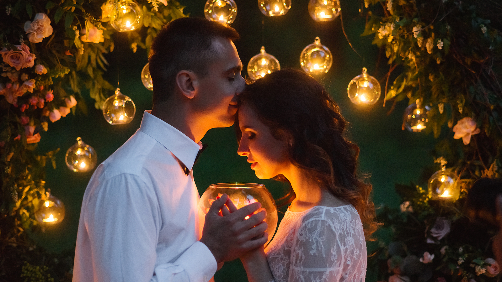 Young beautiful couple on the night wedding ceremony in the forest.
