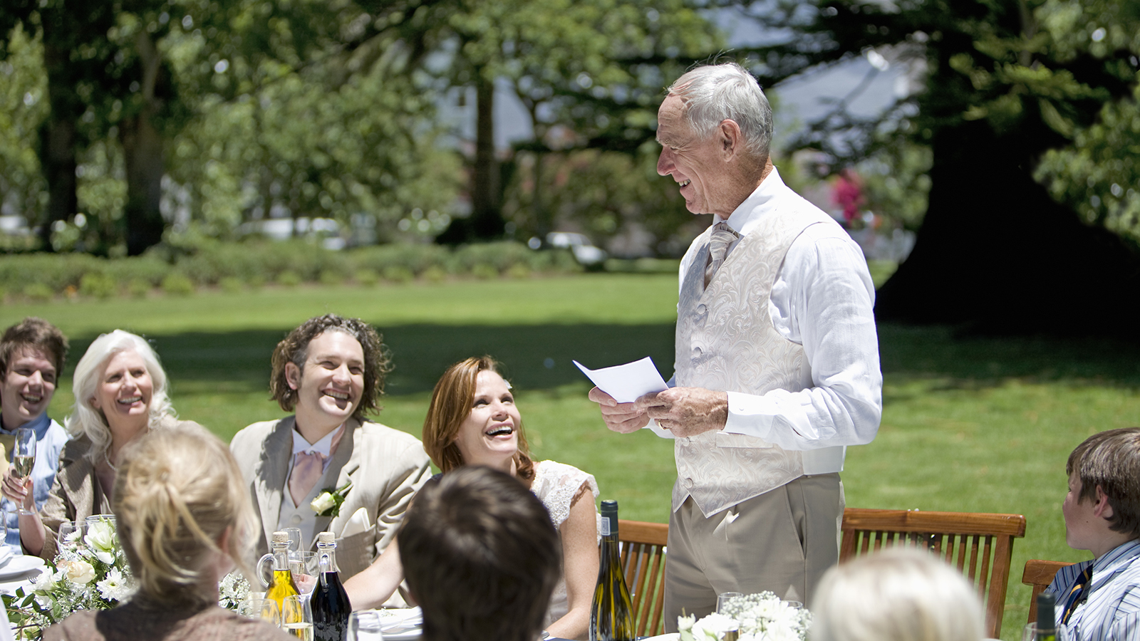 Senior man making a speech at a wedding reception