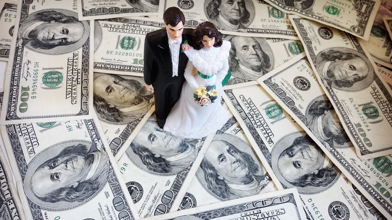 bride and groom cake-topper couple on money