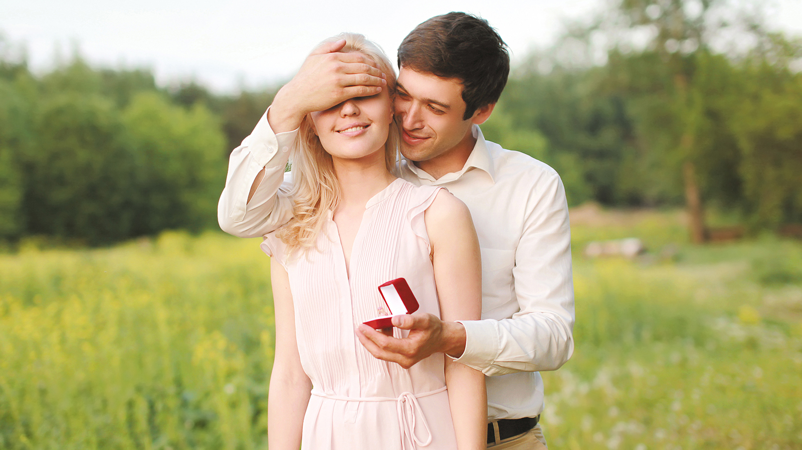 The man closed his eyes a woman, making a surprise ring, engagement ,wedding - concept