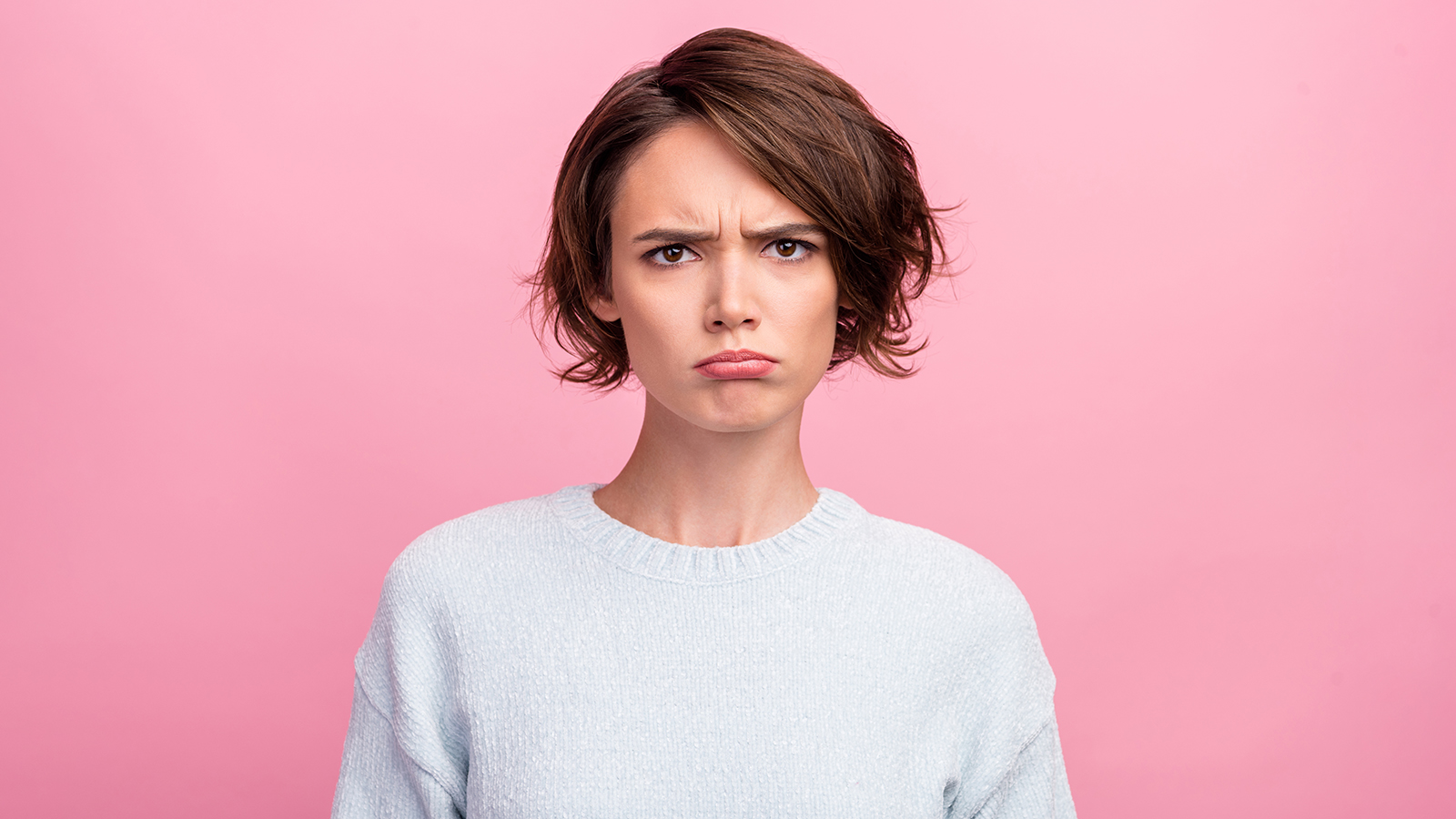 Photo of frustrated grumpy sad lady puffed cheeks lips wear blue sweater isolated pink color background