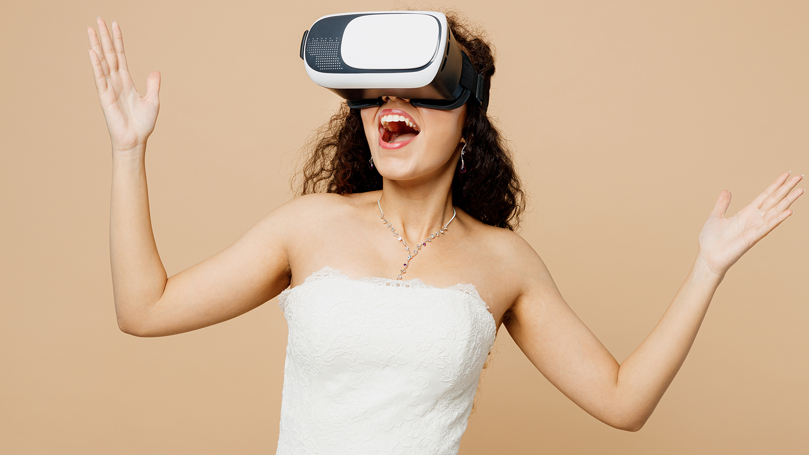 Happy excited beautiful young woman bride wear wedding dress posing watching in vr headset pc gadget isolated on plain pastel light beige background studio portrait. Ceremony celebration party concept