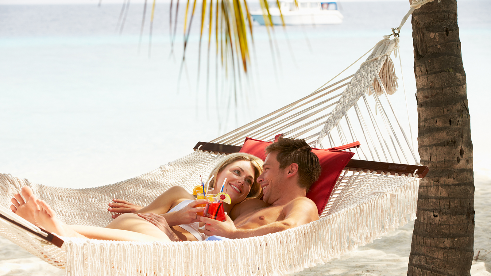 Romantic Couple Relaxing In Beach Hammock