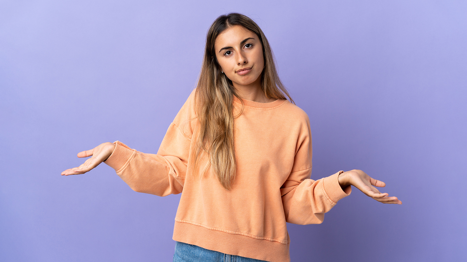 Young hispanic woman over isolated purple background having doubts