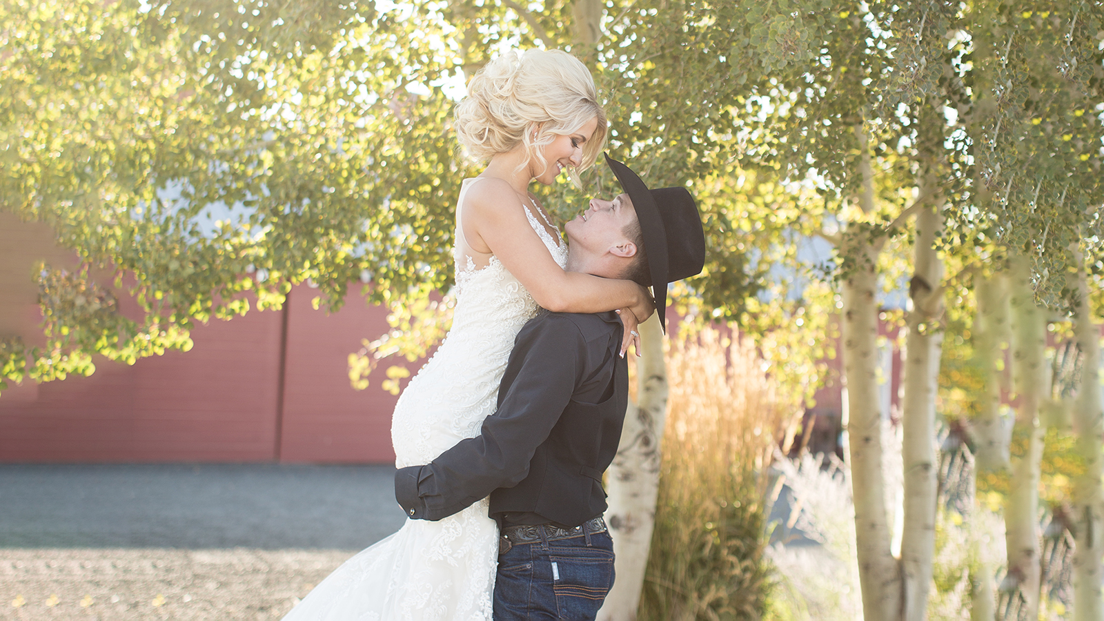Romantic portrait of beautiful young bride and groom laughing un