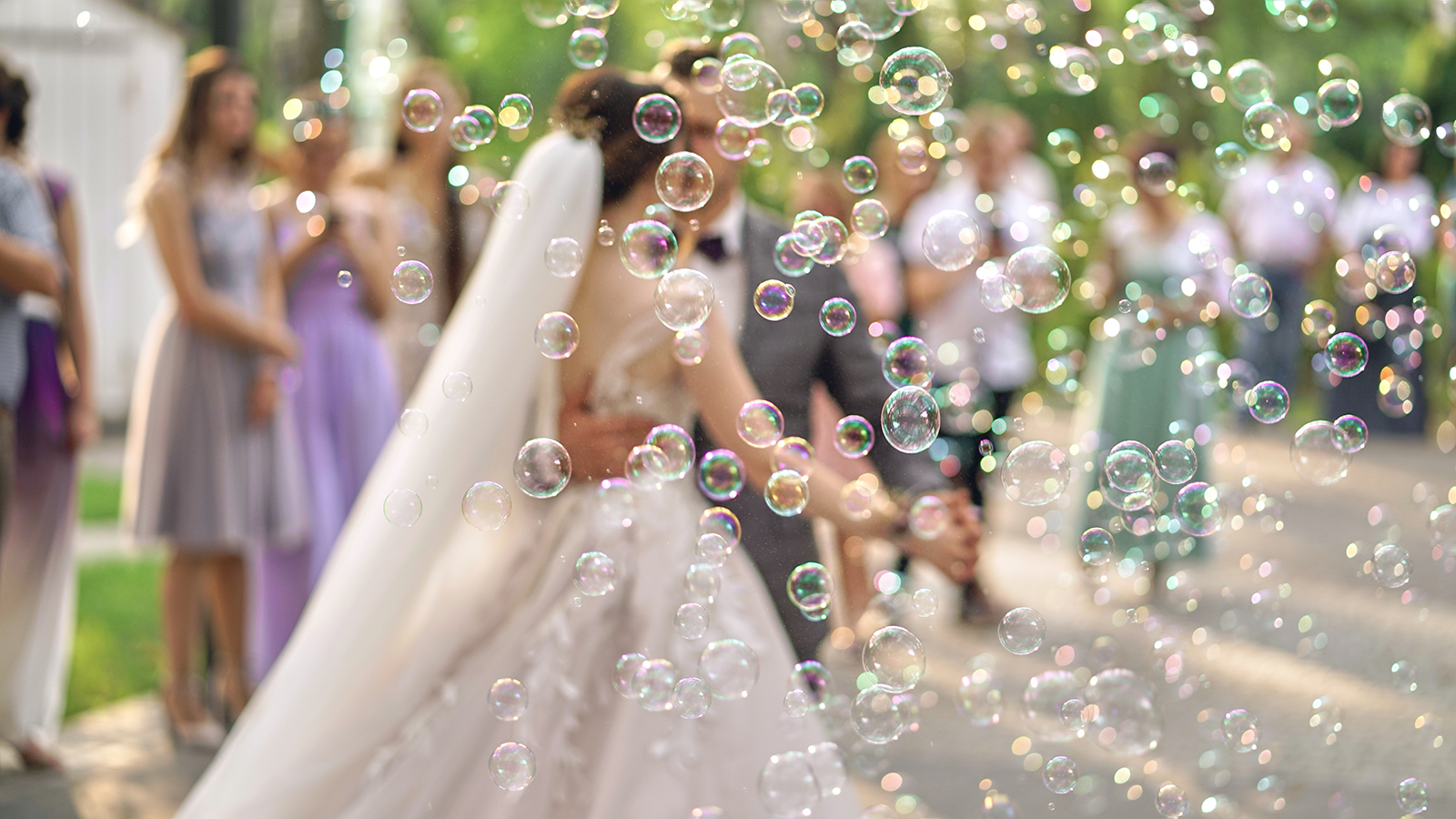 Soap bubbles blurred in the background of the bride