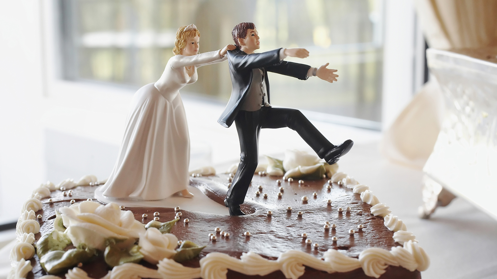Funny wedding cake top, bride chasing groom