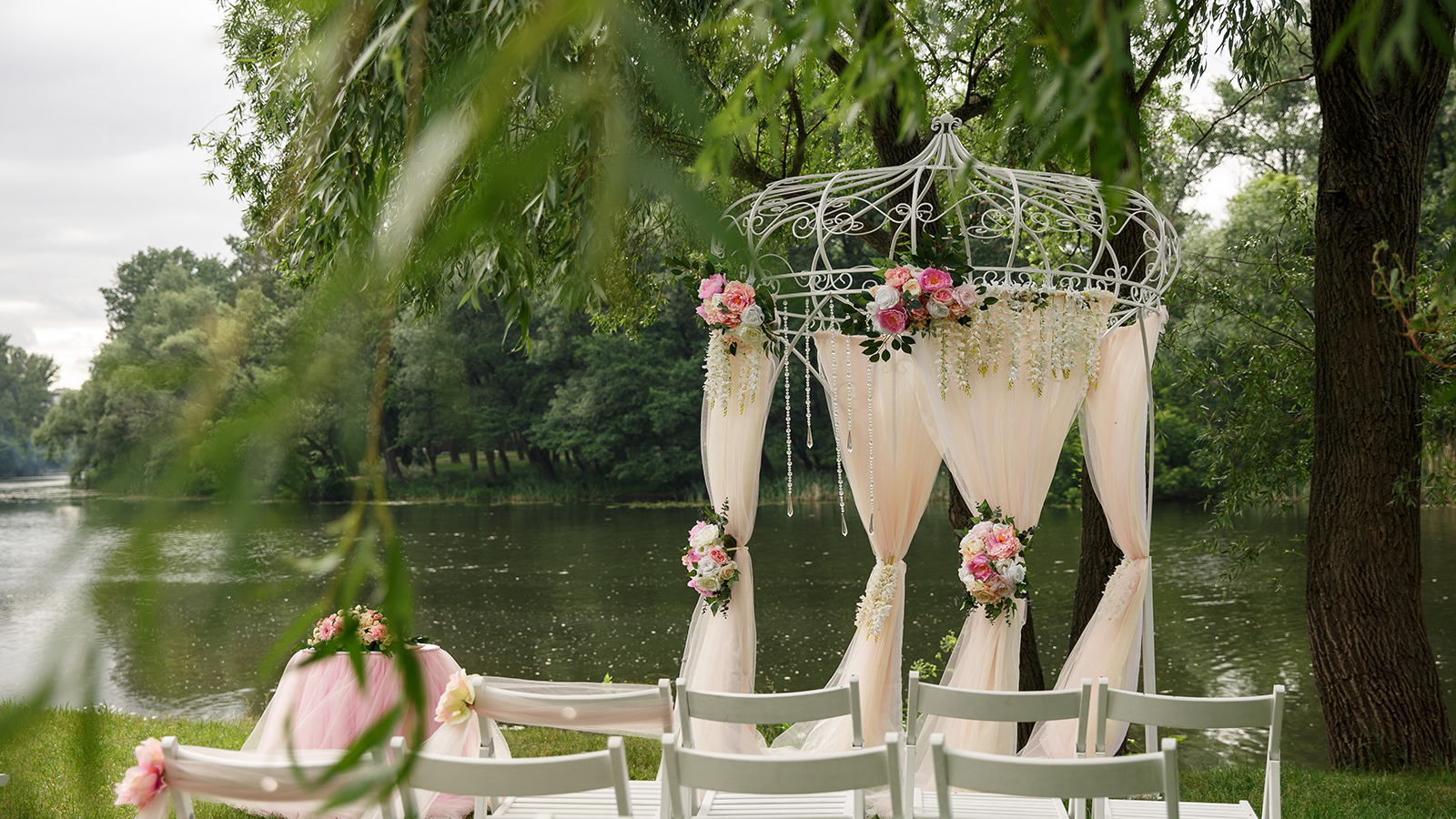 Wedding ceremony outdoor wedding set up with chairs and wedding arch with flowers decoration