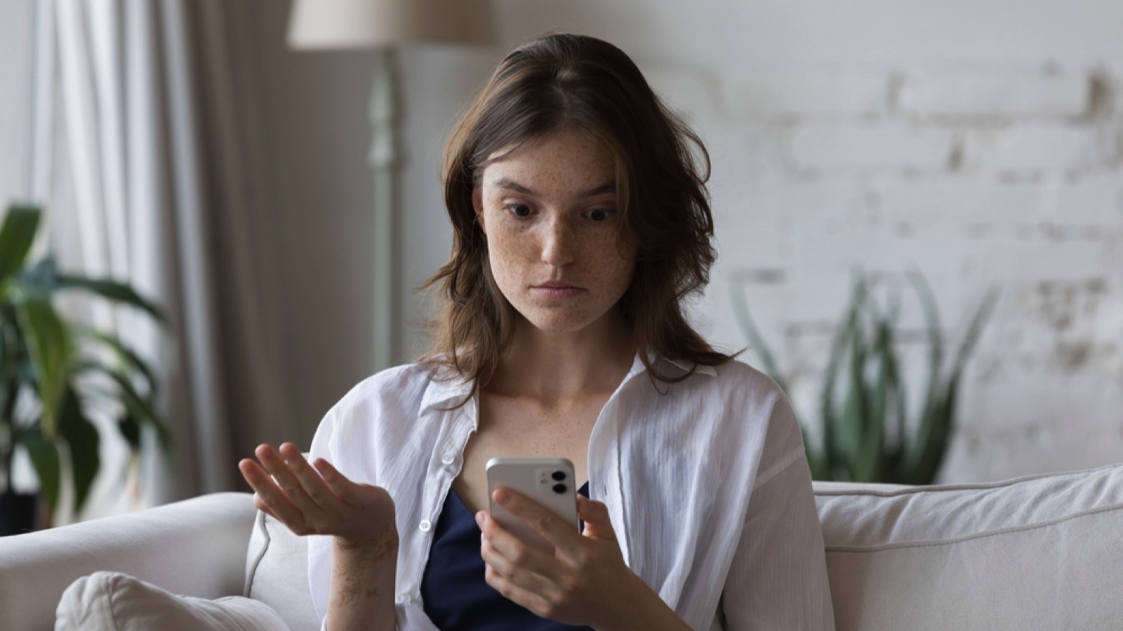 Young woman annoyed using mobile
